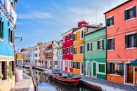 a row of colorful buildings next to a body of water