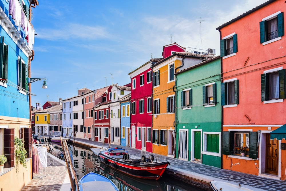 a row of colorful buildings next to a body of water