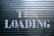 a sign that says it is loading on a garage door