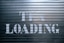 a sign that says it is loading on a garage door