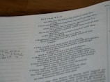 A close-up of a page from a book featuring text from the book of Isaiah. The passage includes verses and is printed in a traditional serif font. The text is black on a white background with a margin on the left including some handwritten notes.