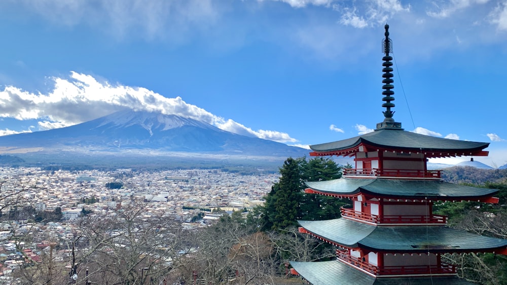 a tall pagoda with a mountain in the background