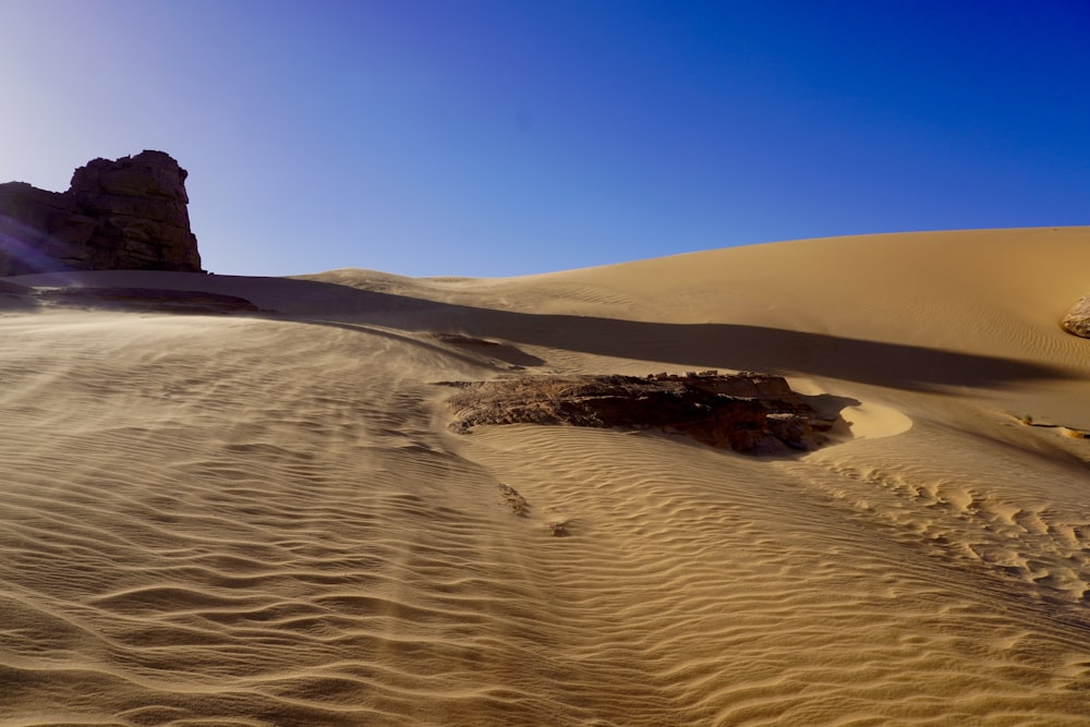 a rock in the middle of a desert