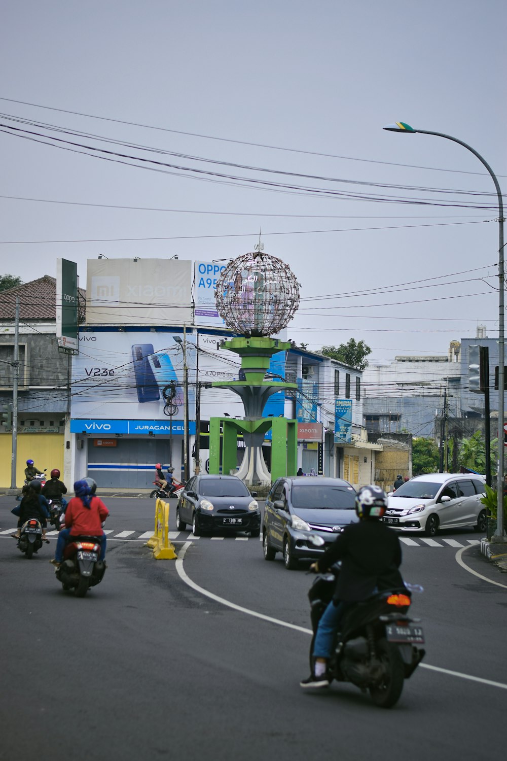 a group of people riding motorcycles down a street