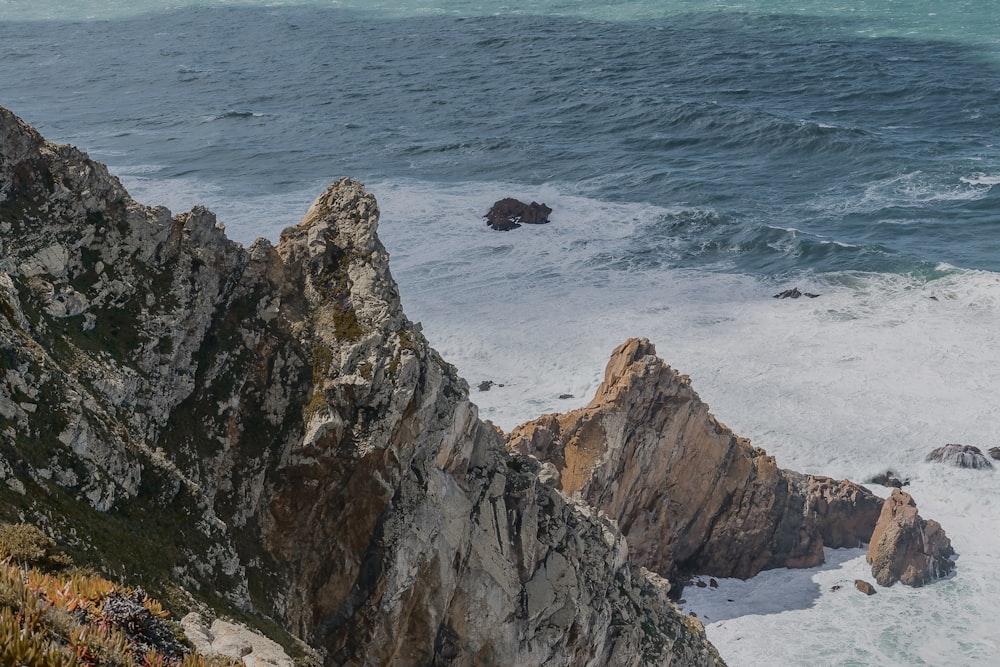 a rocky coastline with waves crashing against the rocks