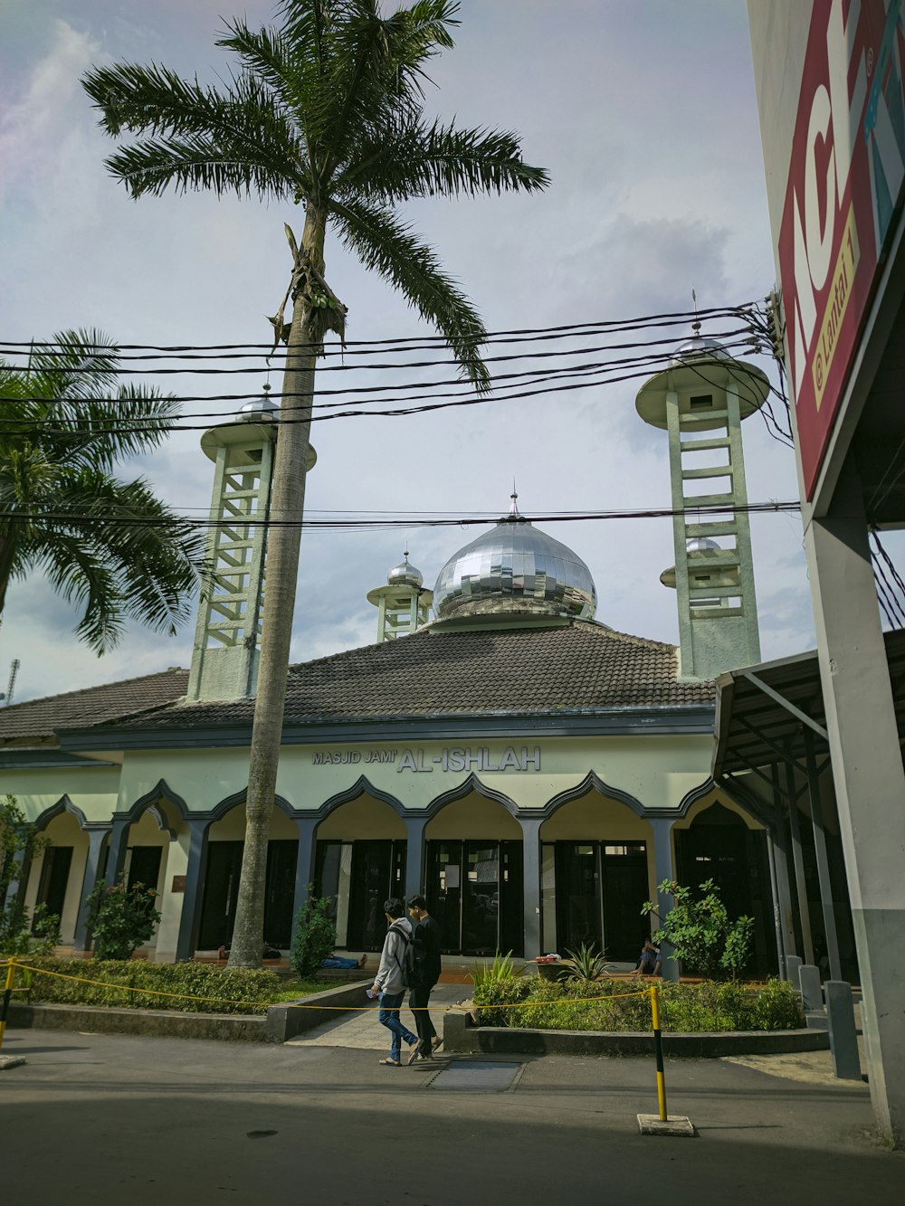 a building with a palm tree in front of it