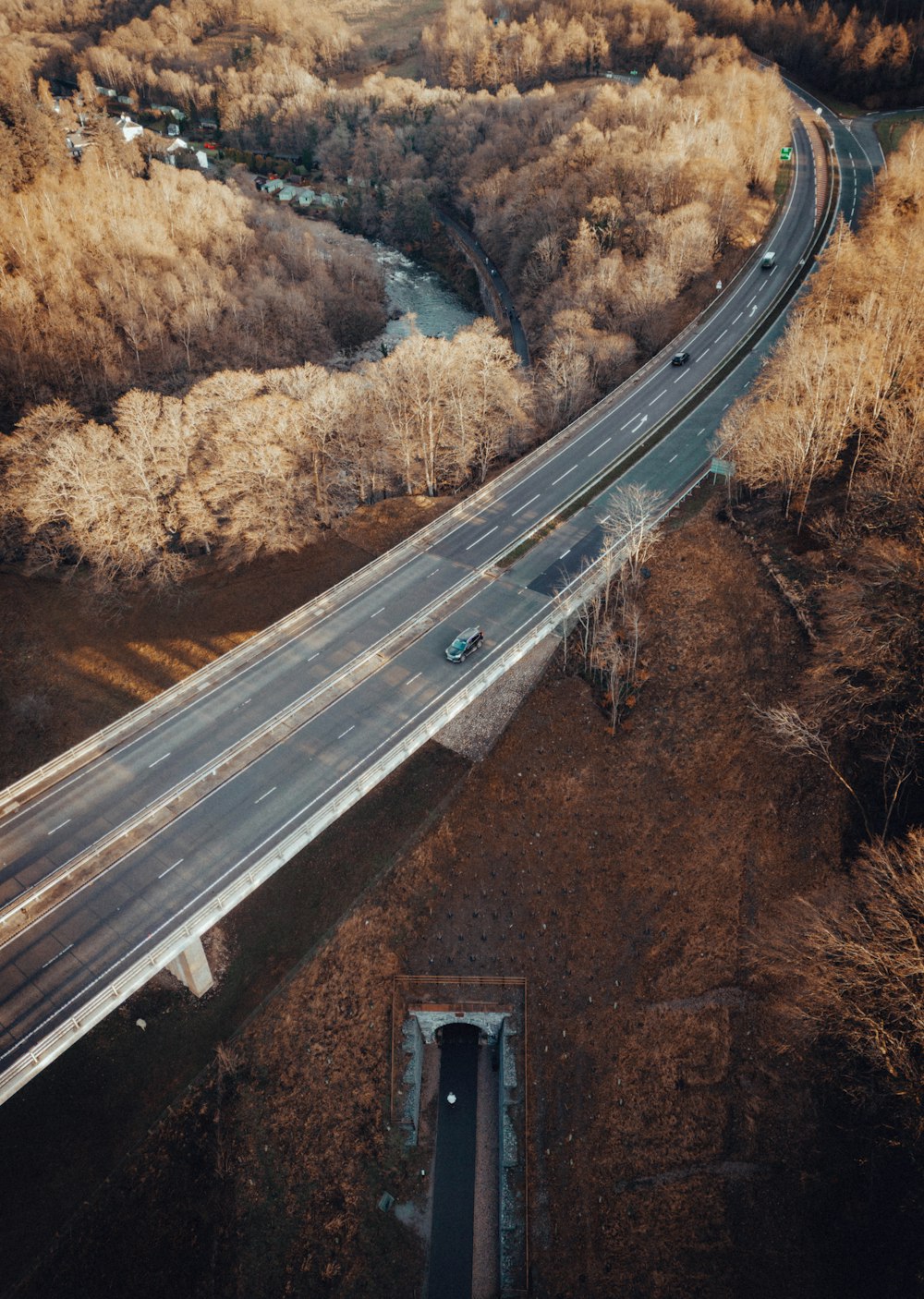 an aerial view of a highway in a wooded area