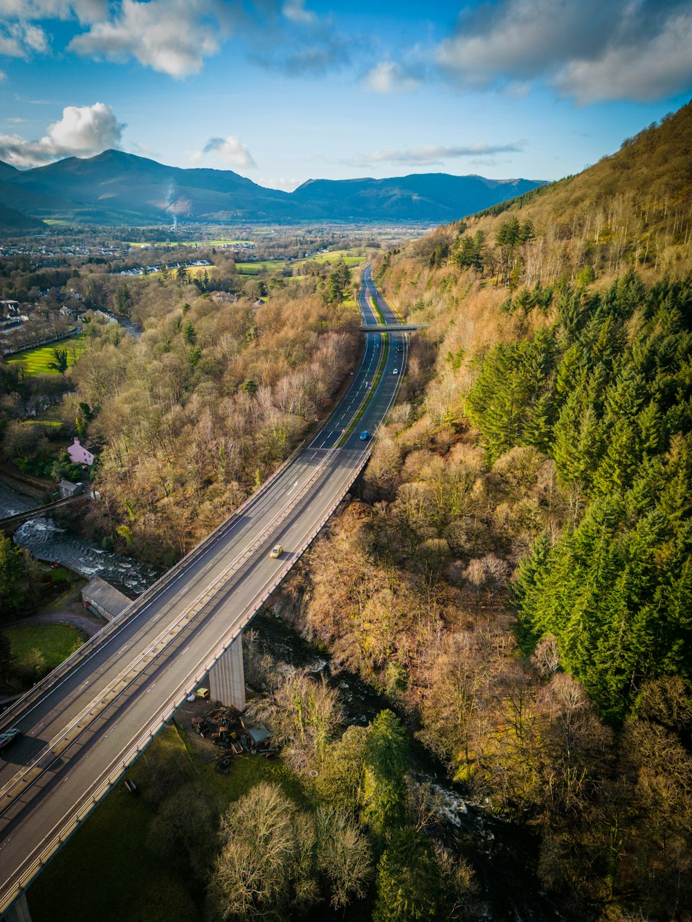 an aerial view of a highway in the mountains
