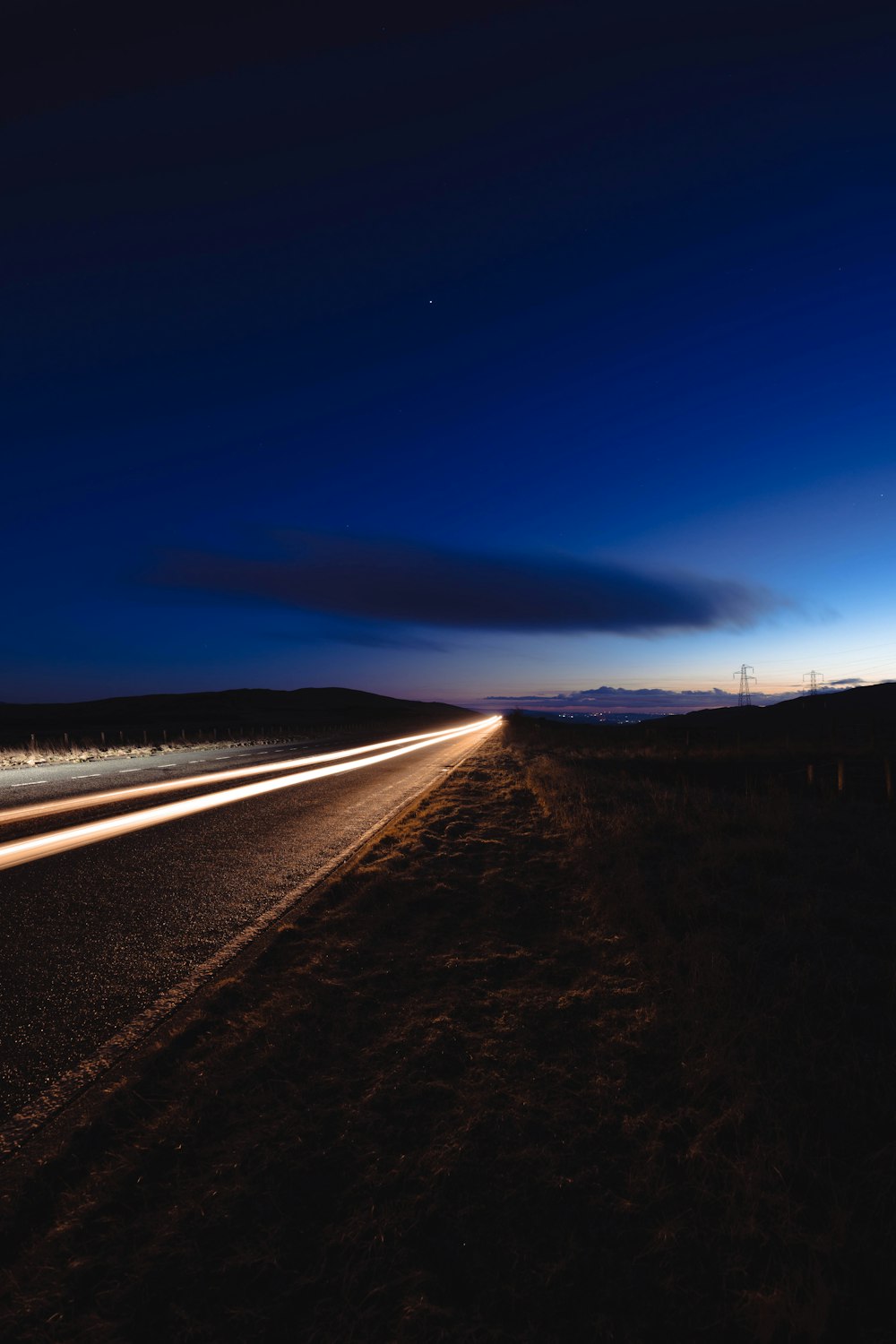 a long exposure photo of a highway at night