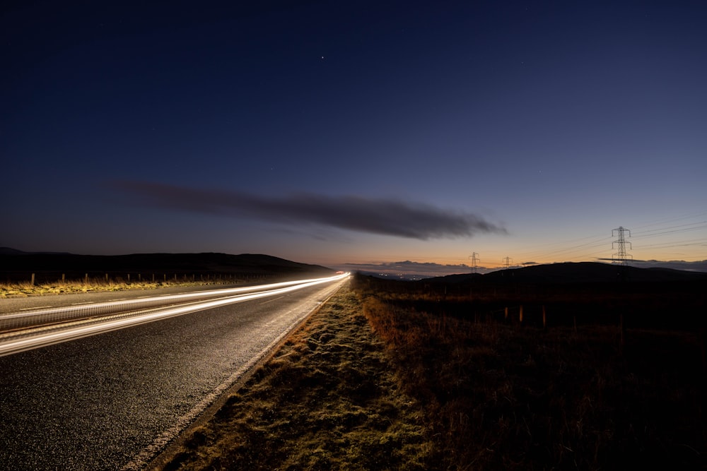 a long road with a sky background at night