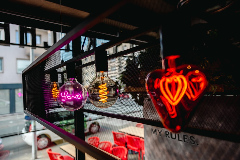 a couple of neon signs hanging from the side of a building