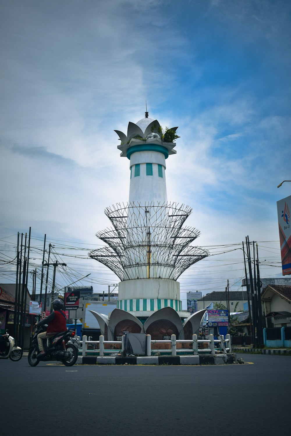 a tall white tower with a clock on top of it