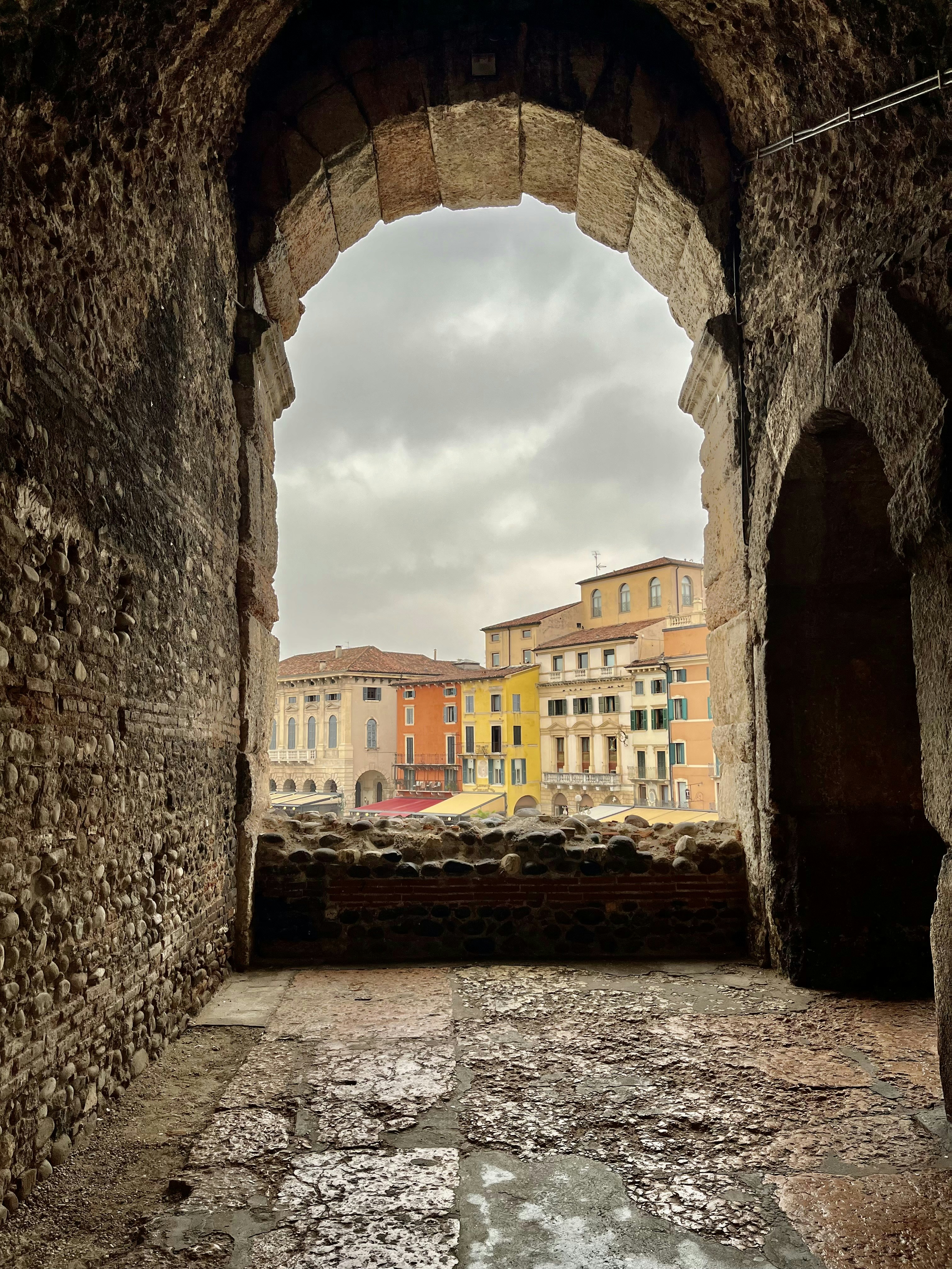 a view of a city through a stone archway
