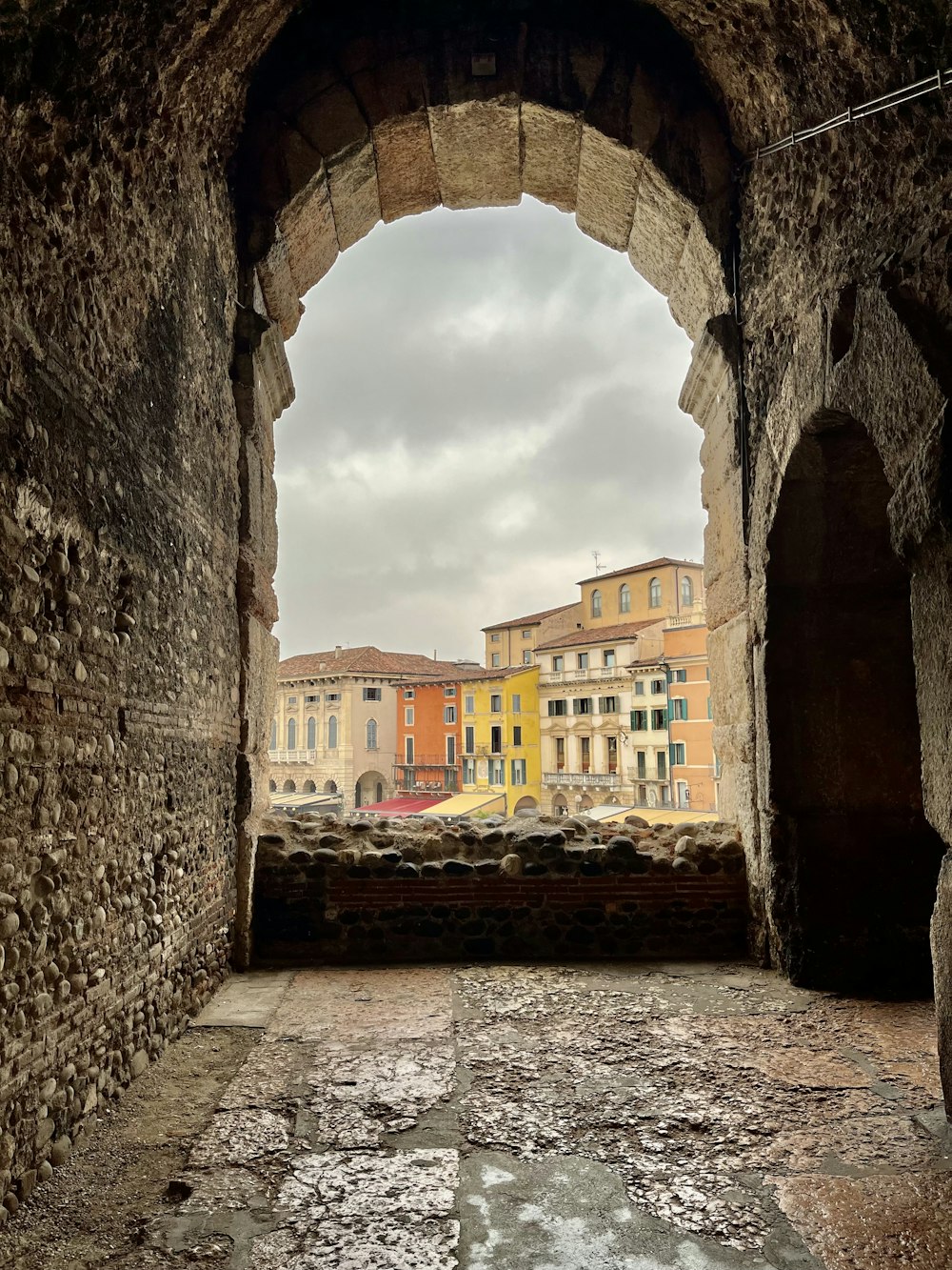a view of a city through a stone archway