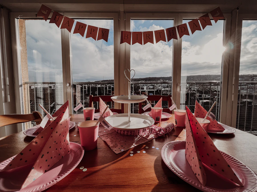 Party table set with plates, cups and a decorated table cover