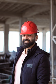 a man wearing a red hard hat and jacket