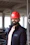 a man wearing a red hard hat and jacket