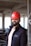 a man wearing a red hard hat and jacket