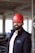 a man wearing a red hard hat and jacket
