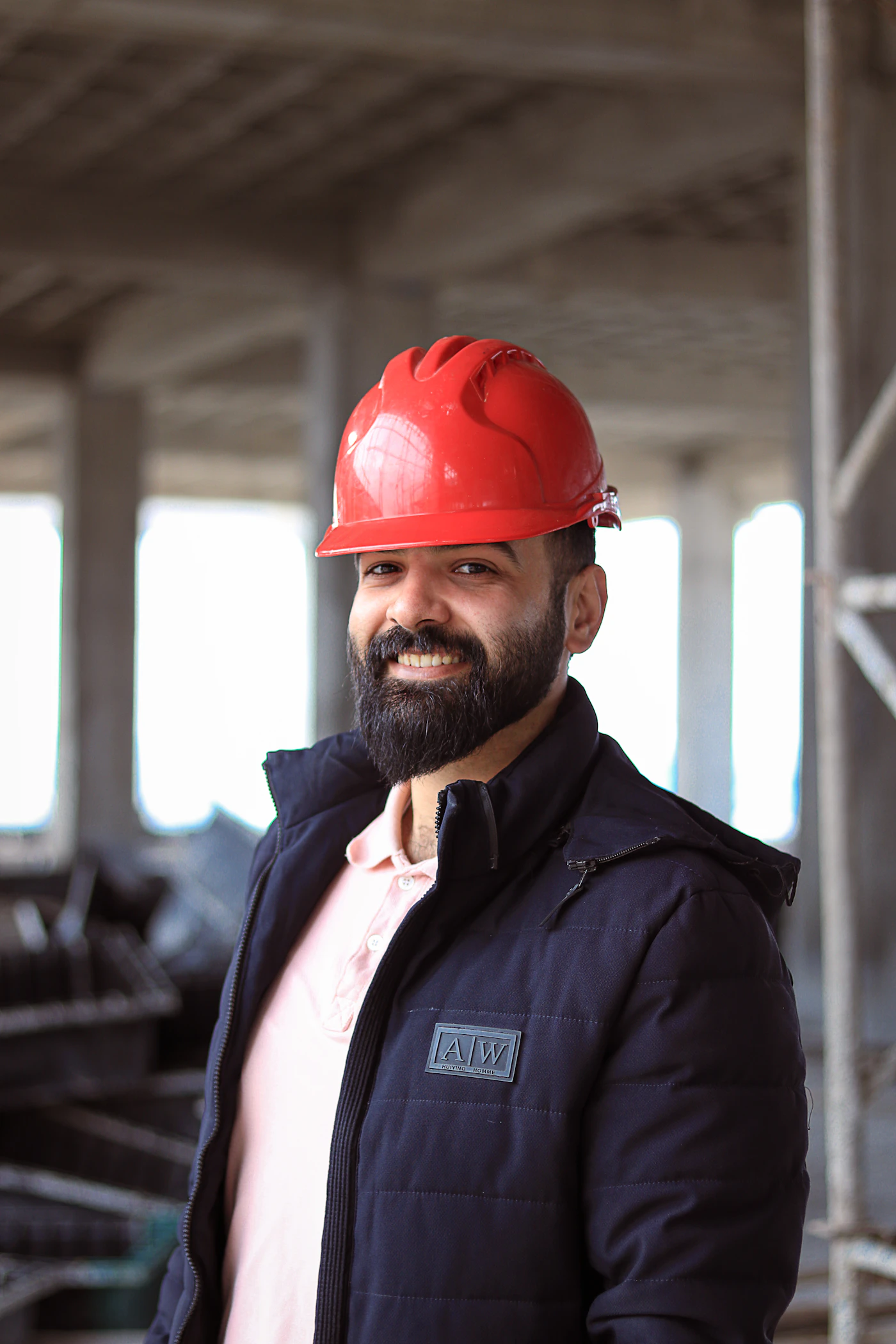 Worker in a red hard hat and jacket representing nationwide site coverage