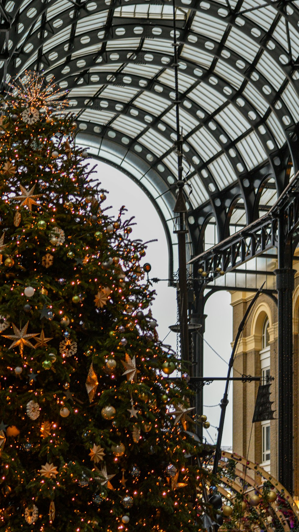 a large christmas tree in front of a building