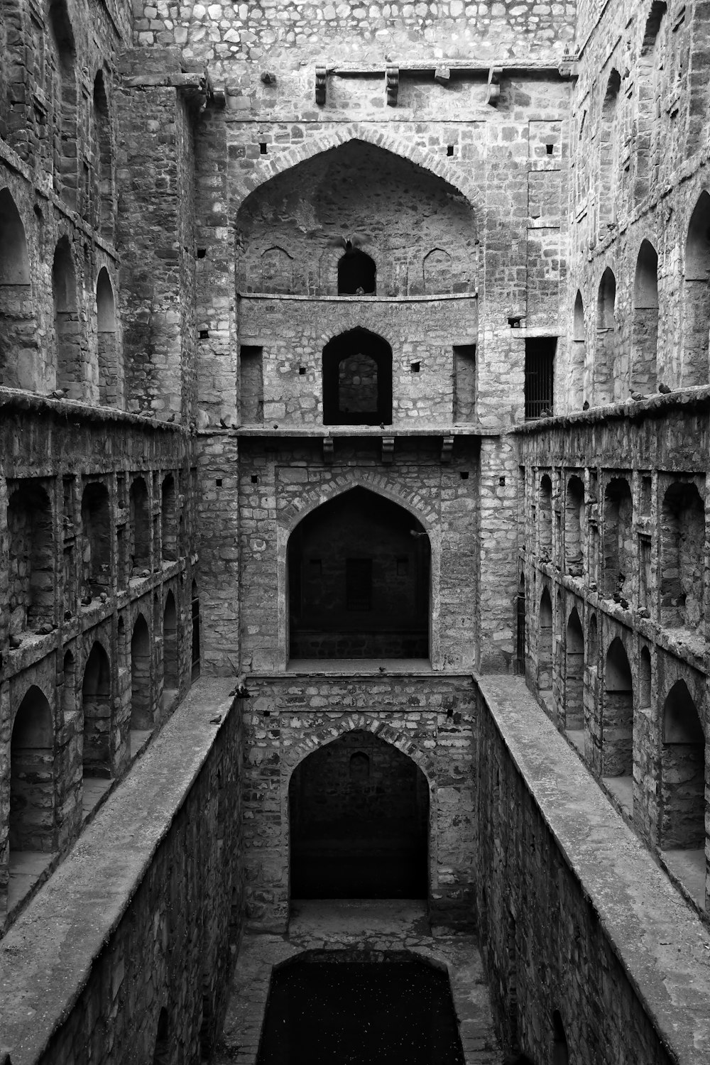 an old building with stone walls and arches