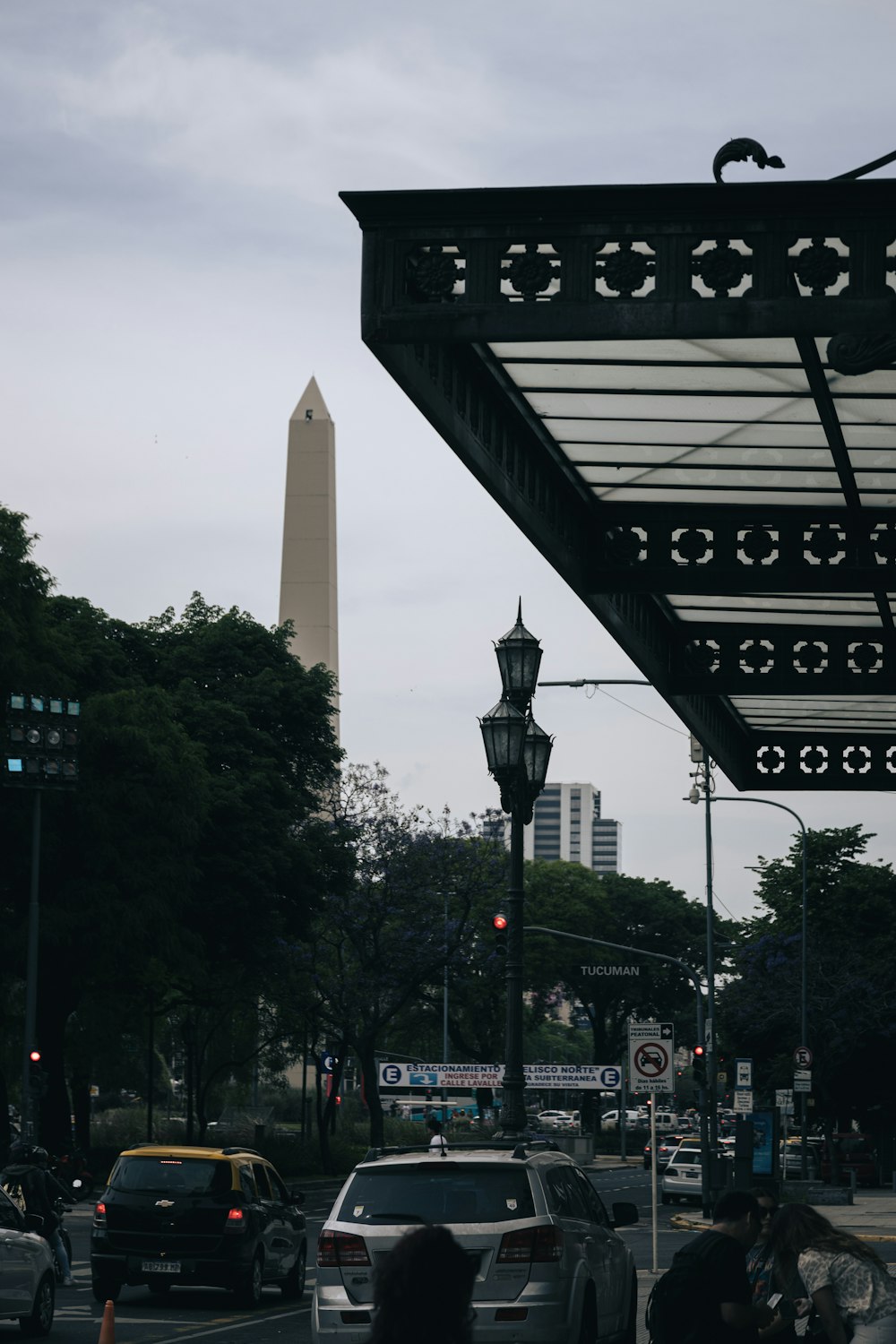 a view of a street with a tall building in the background