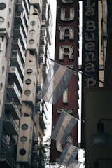 Colorful street banners and flyers promoting a local business in a vibrant Argentine neighborhood.