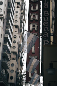 Colorful street banners and flyers promoting a local business in a vibrant Argentine neighborhood.