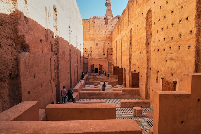 The ruined pise walls of El Badi Palace, pocked with nesting holes, around the sunken garden.