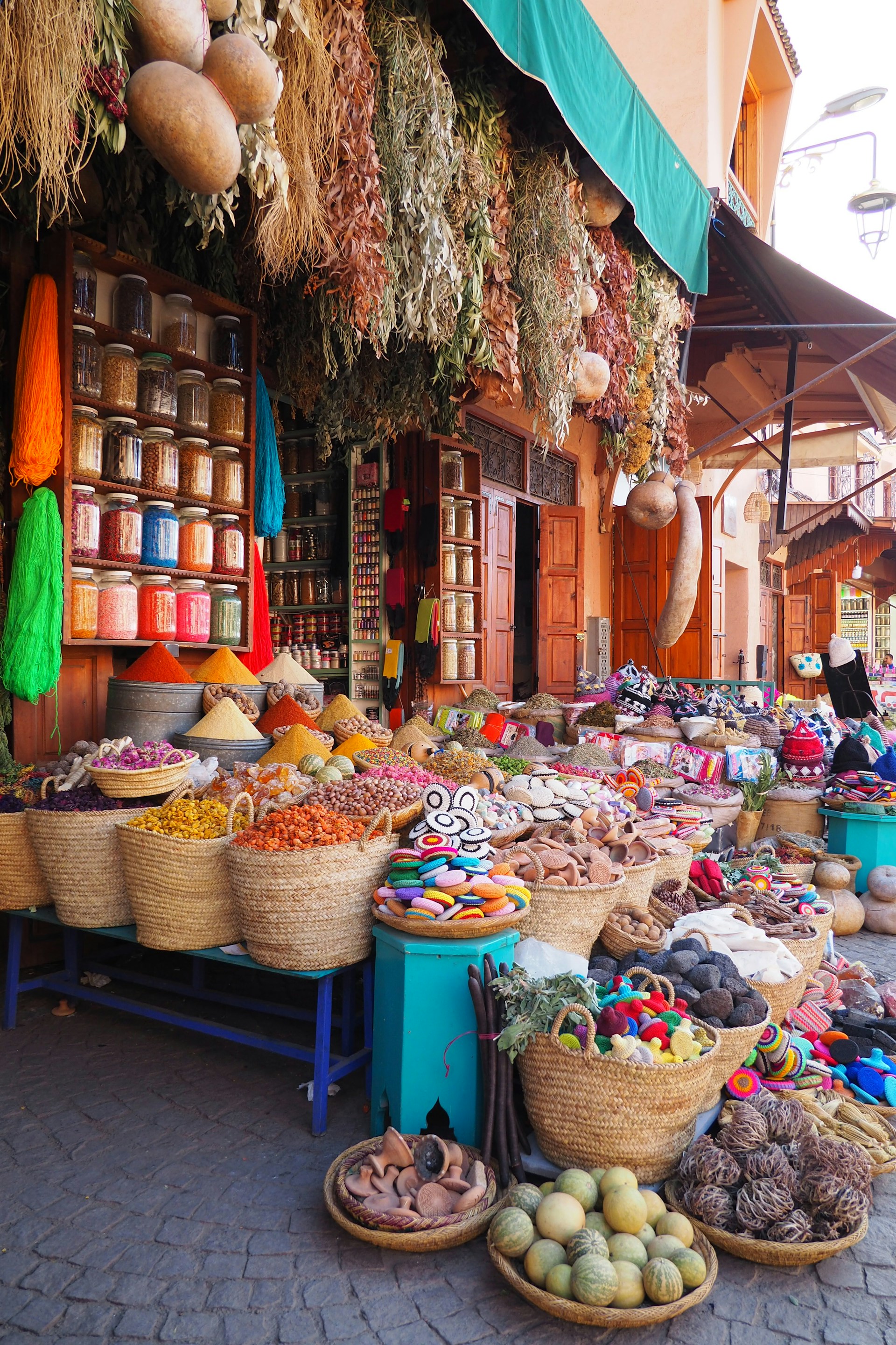 an outdoor market with baskets of food on display