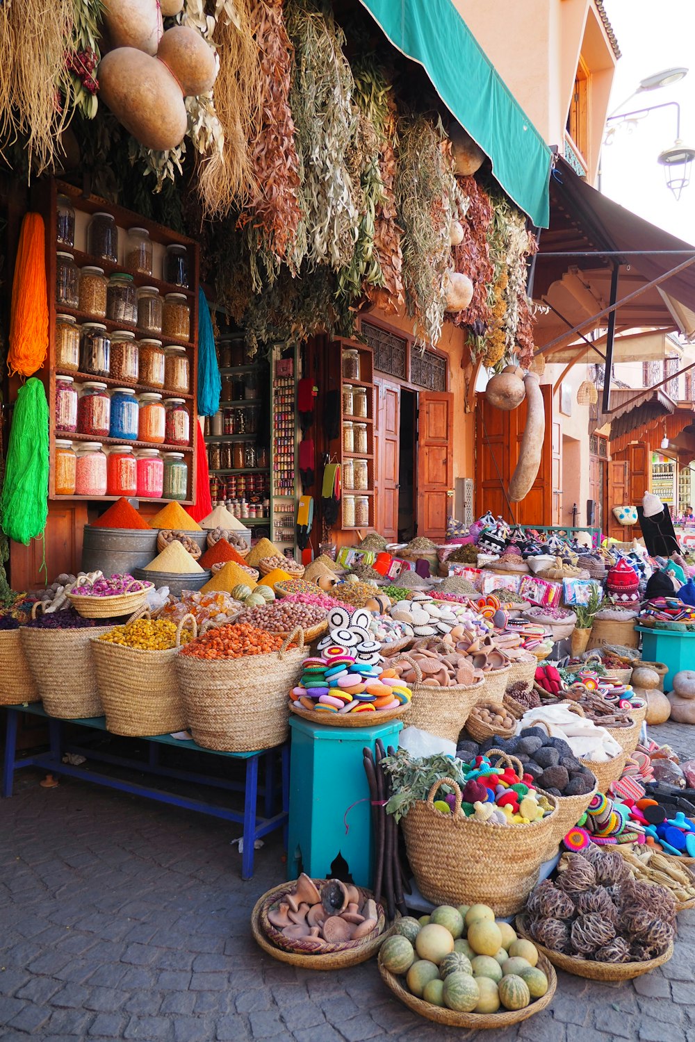 an outdoor market with baskets of food on display