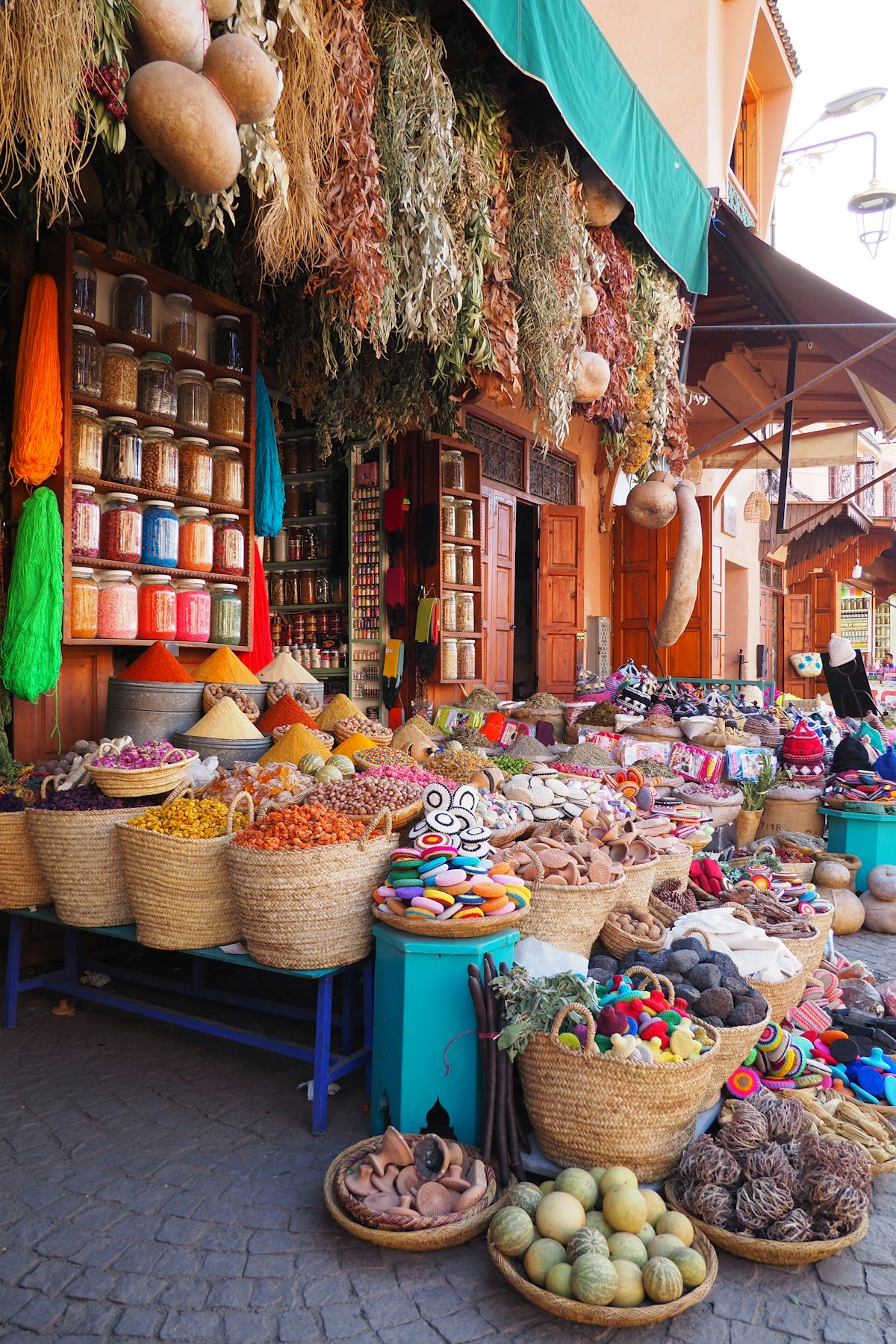 an outdoor market with baskets of food on display