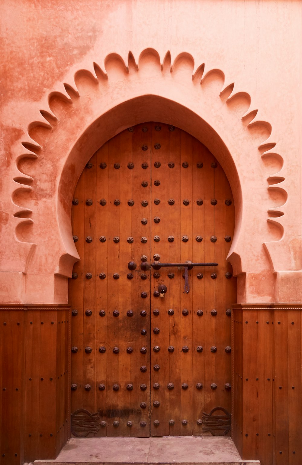 a large wooden door with a decorative arch above it