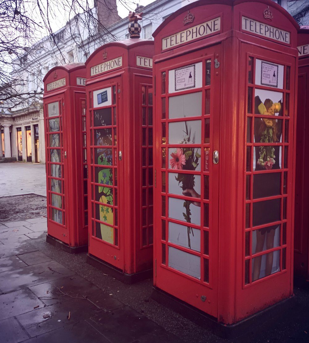 a row of red telephone booths sitting next to each other