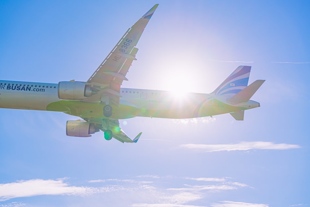 a large jetliner flying through a blue sky