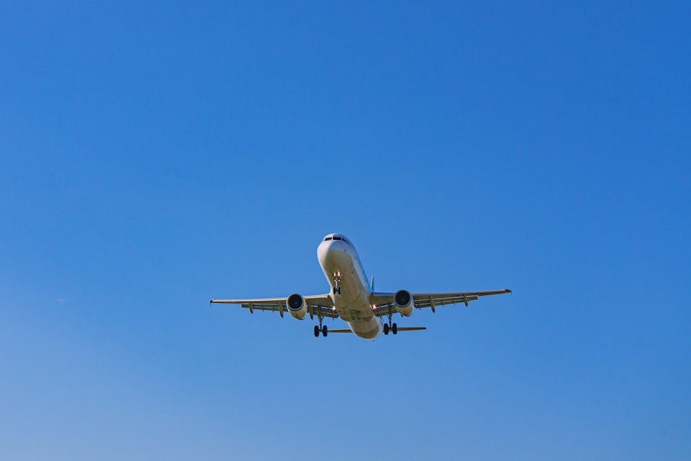 a large jetliner flying through a blue sky