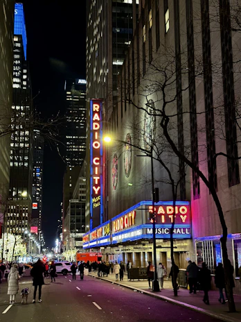 A lively street corner in New York City with musicians playing passionately under glowing city lights.