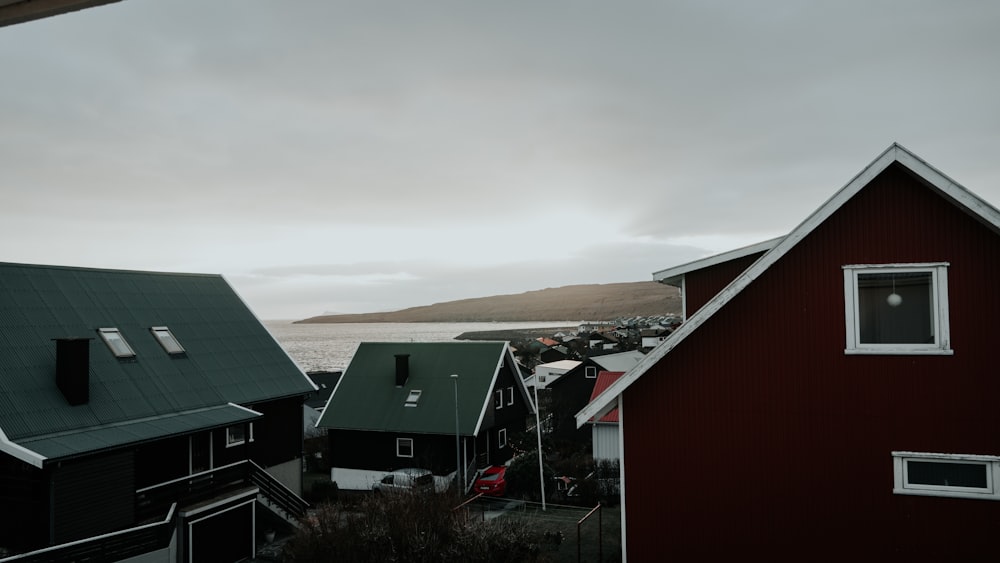 a couple of houses sitting next to a body of water