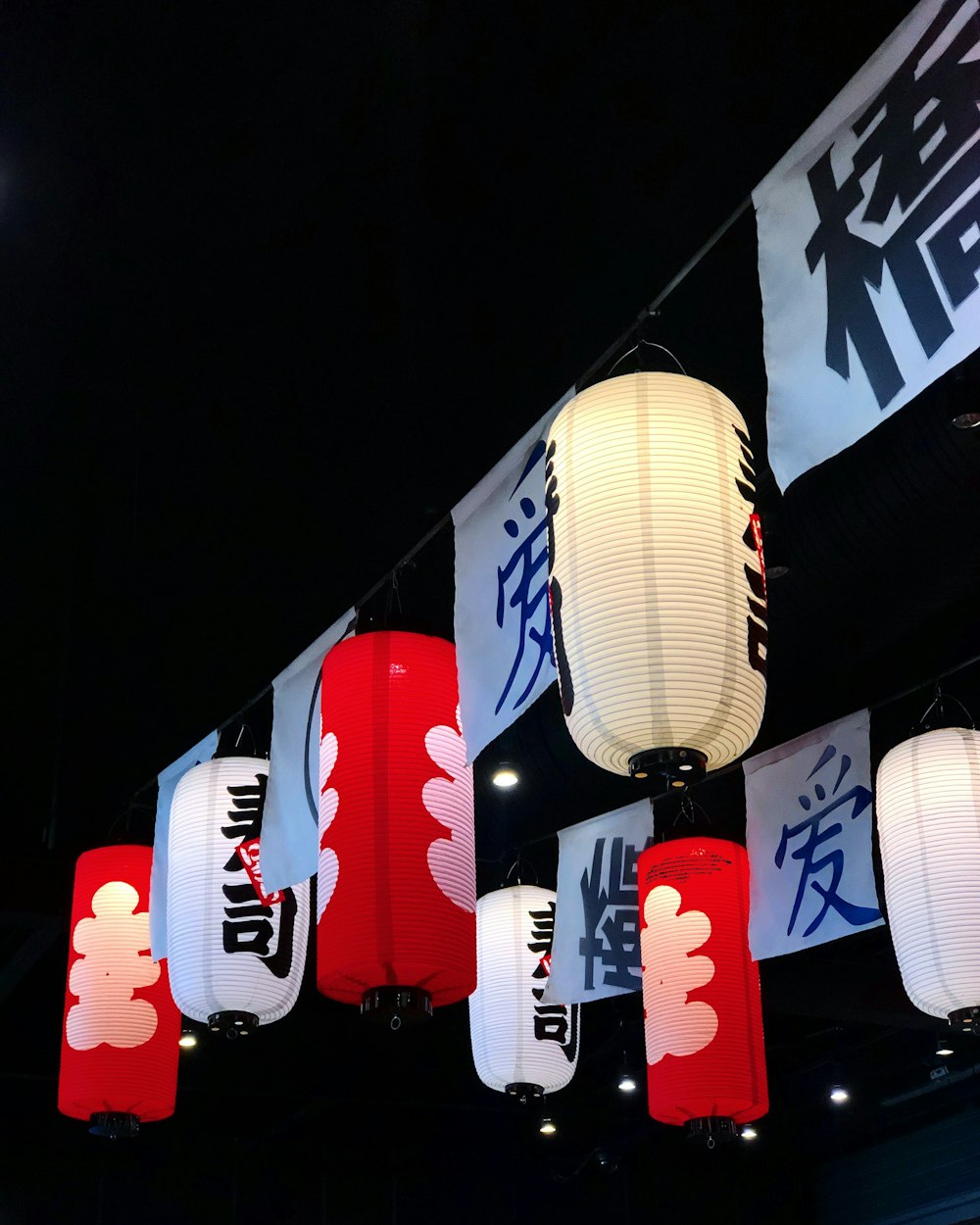 a number of lanterns hanging from a ceiling