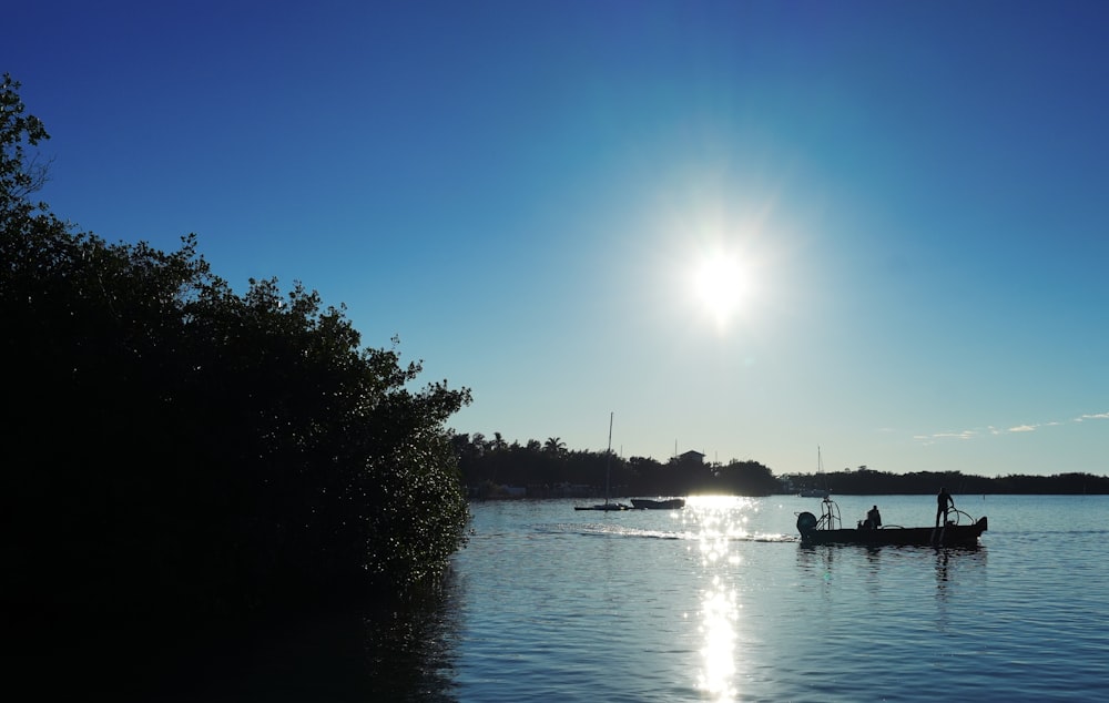 a couple of boats floating on top of a lake