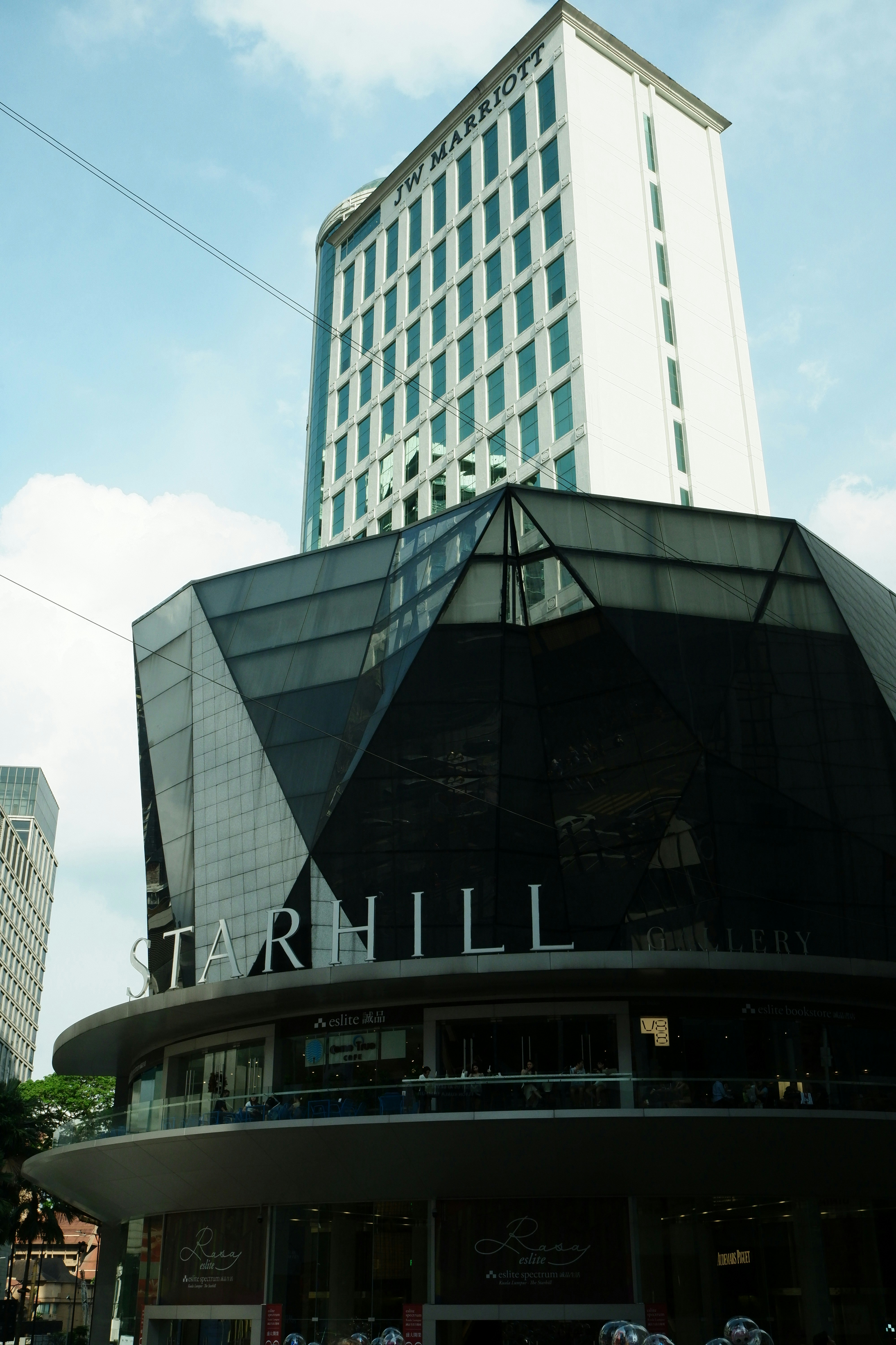 A tall building sitting next to a tall building photo – Free Bukit ...