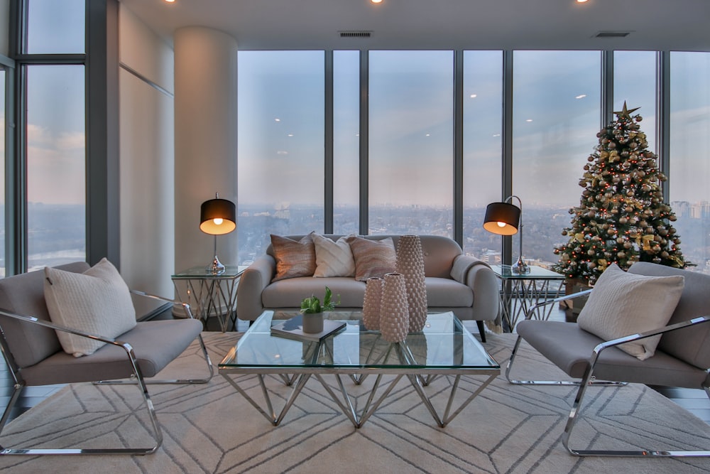 a living room filled with furniture and a christmas tree