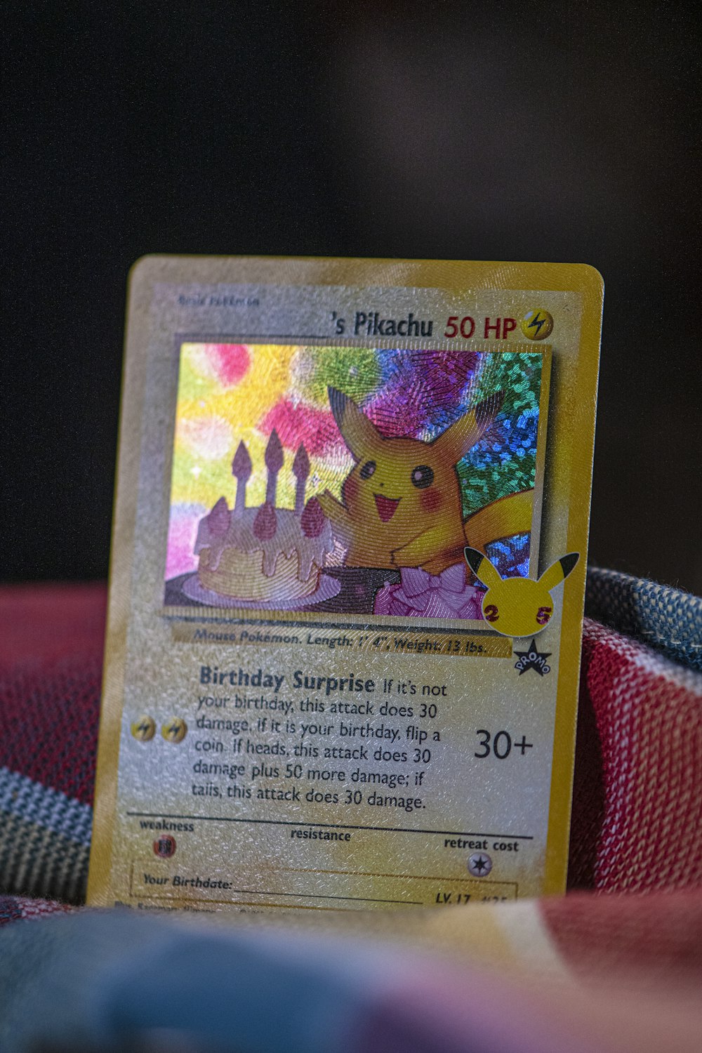 a pokemon trading card sitting on top of a blanket