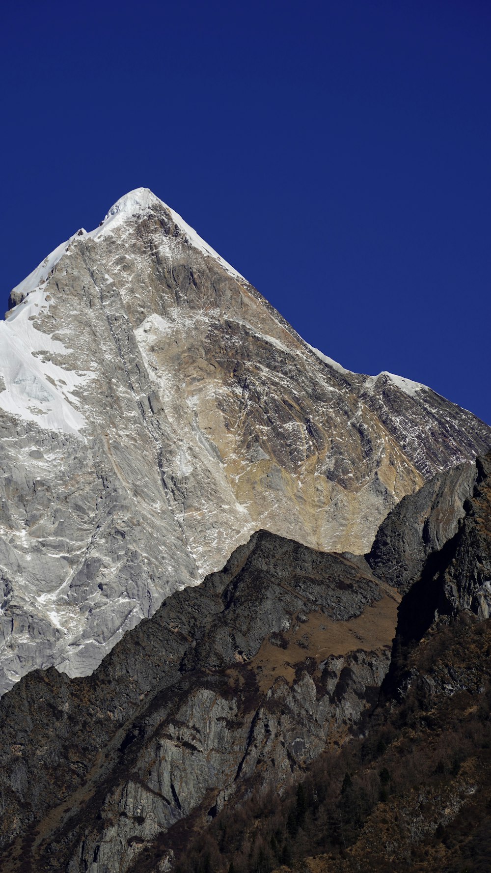 a snow covered mountain with a clear blue sky