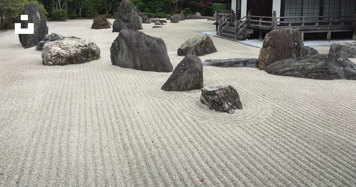 A japanese garden with rocks and a building photo – Free Building Image ...