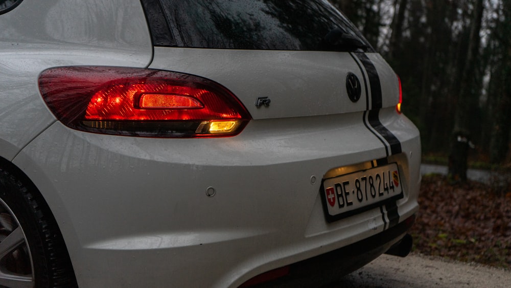 a close up of the tail lights of a white car