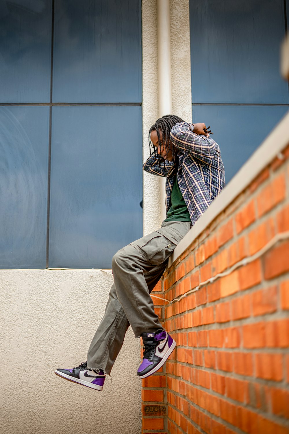 a man standing on top of a brick wall