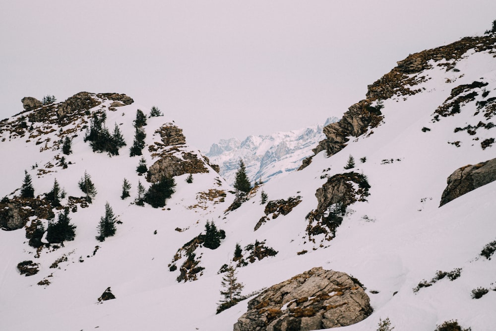 a man riding skis down a snow covered slope