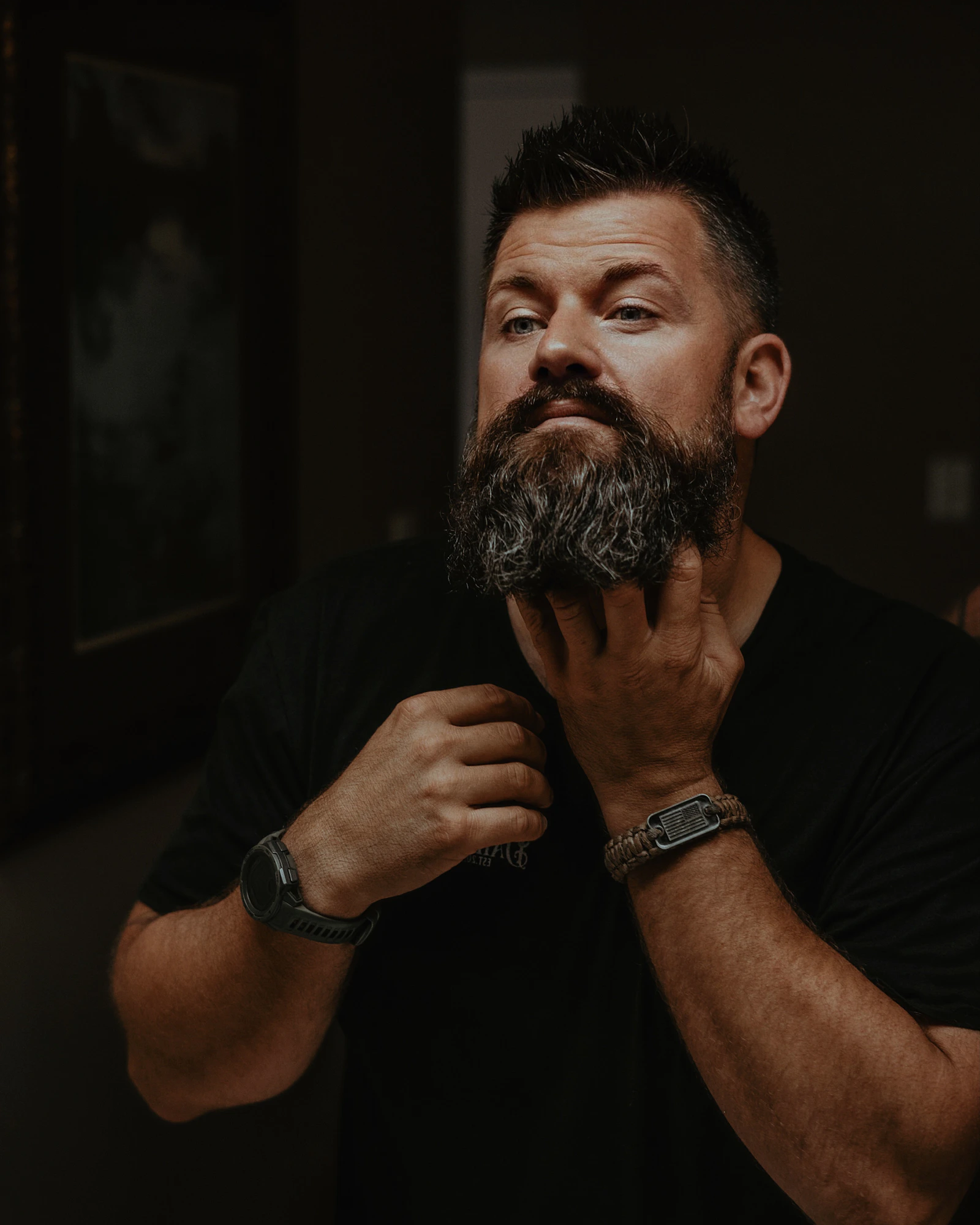 Bearded man grooming his beard